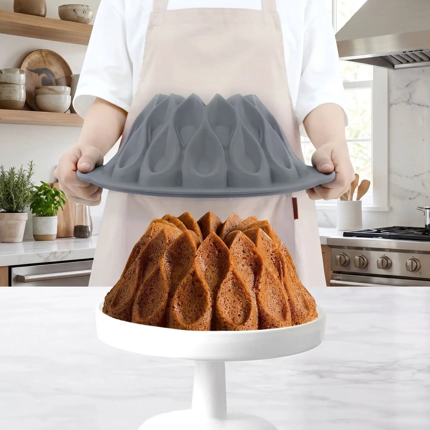 moule gateau slicone gris dans les mains en train de retirer le gateau cuit