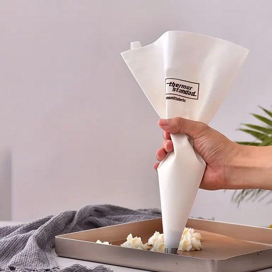 Poche à douille blanche en coton faisant des petits gateaux